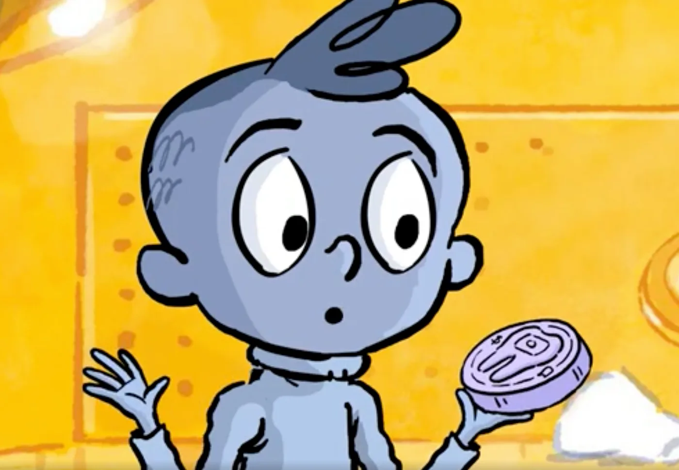 Arlo looking surprised as he holds up the purple ToothSafe disc, roughly the size of a hockey puck